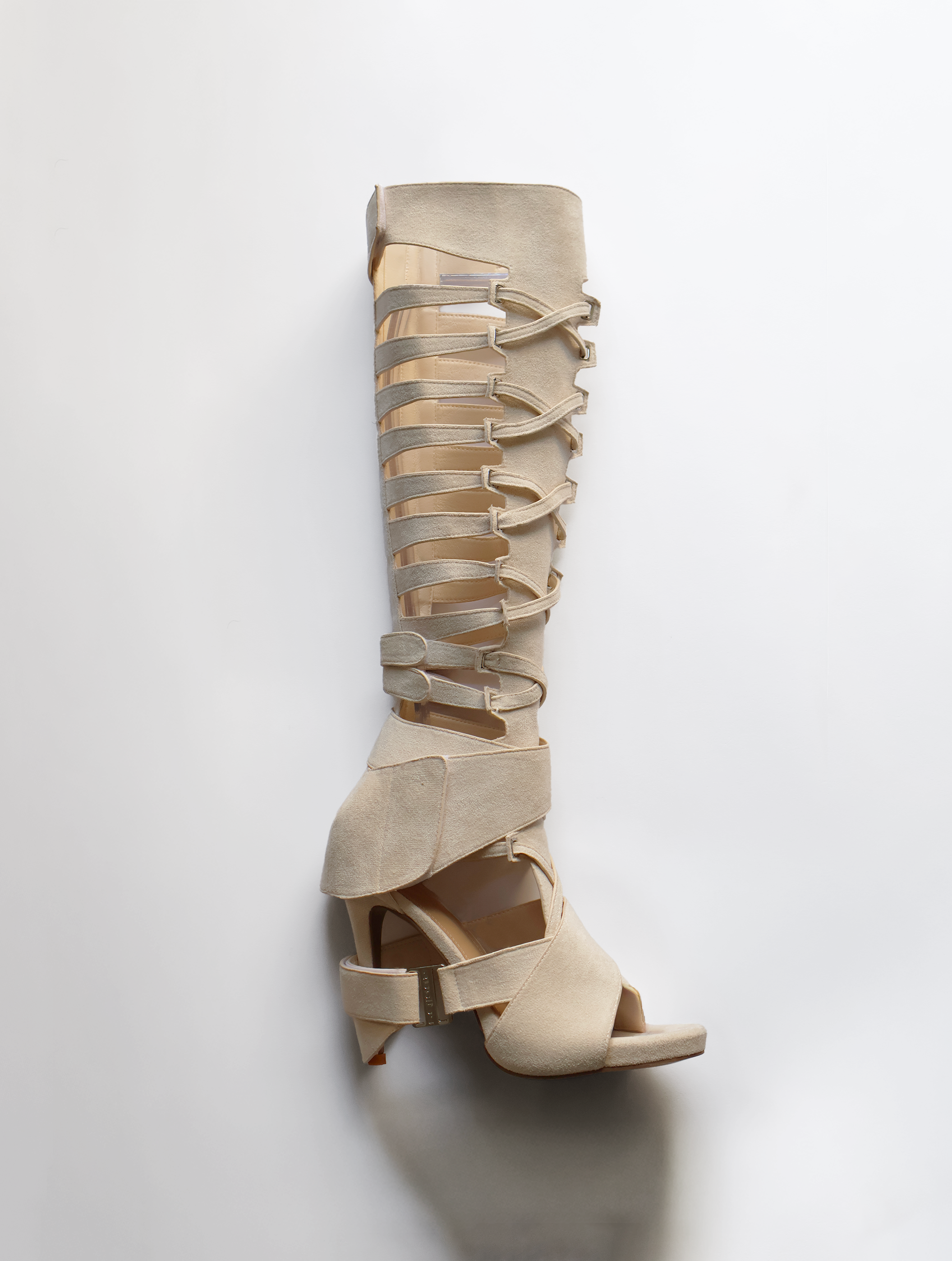 Beige high-heeled sandals with multiple straps on a white background